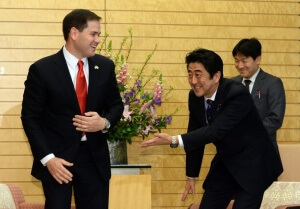 epa04033752 US Senator Marco Rubio (L) is greeted by Japanese Prime Minister Shinzo Abe (2-R) prior to their talks at Abe's office in Tokyo, Japan, 21 January 2014. Rubio, a member of US Senate Foreign Relations Committee, is in Japan to exchange diplomatic views with Japanese officials.  EPA/YOSHIKAZU TSUNO/POOL